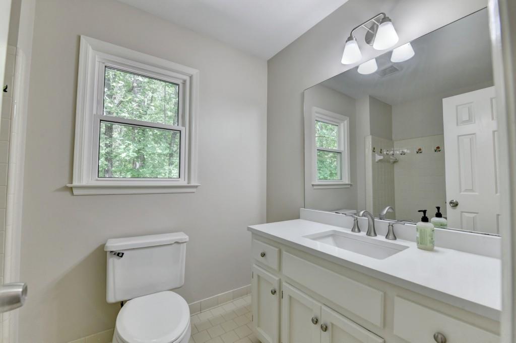 3791 Old Bridge Way Duluth, GA 30096 - Photo 45 of 58 a bathroom with a toilet a sink and mirror