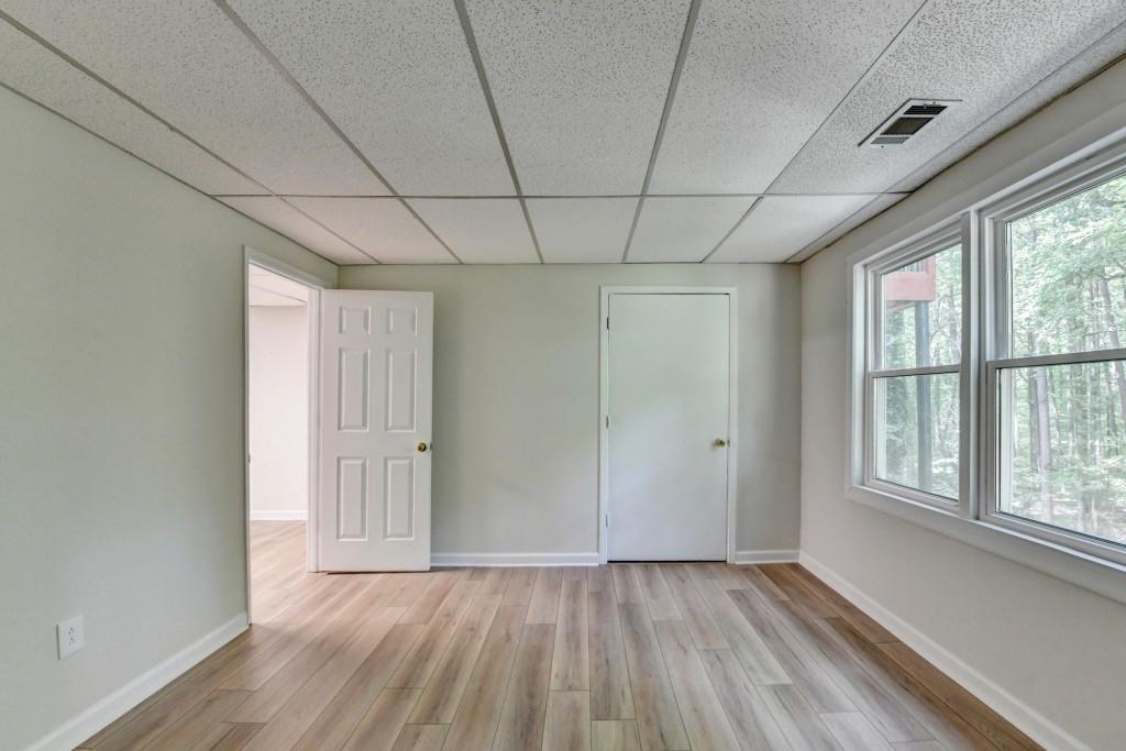 3791 Old Bridge Way Duluth, GA 30096 - Photo 52 of 58 a view of an empty room with a window and wooden floor