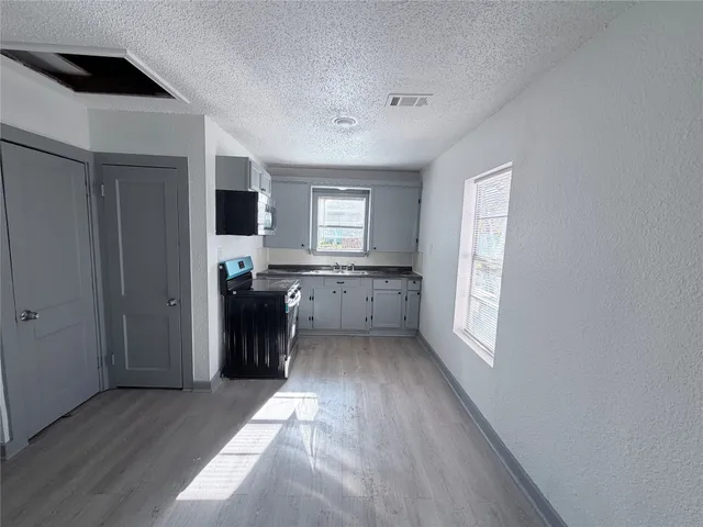 a view of a kitchen cabinets a sink and a window