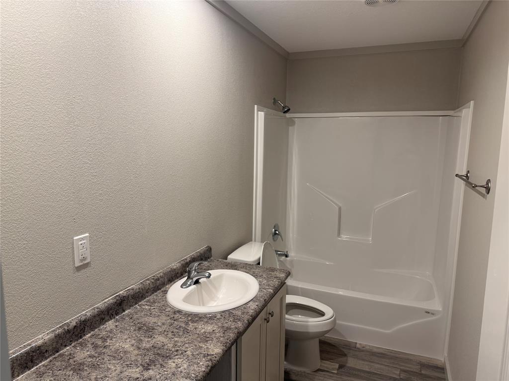 358 Reast Road Whitesboro, TX 76273 - Photo 13 of 21 a bathroom with a granite countertop sink toilet and a mirror