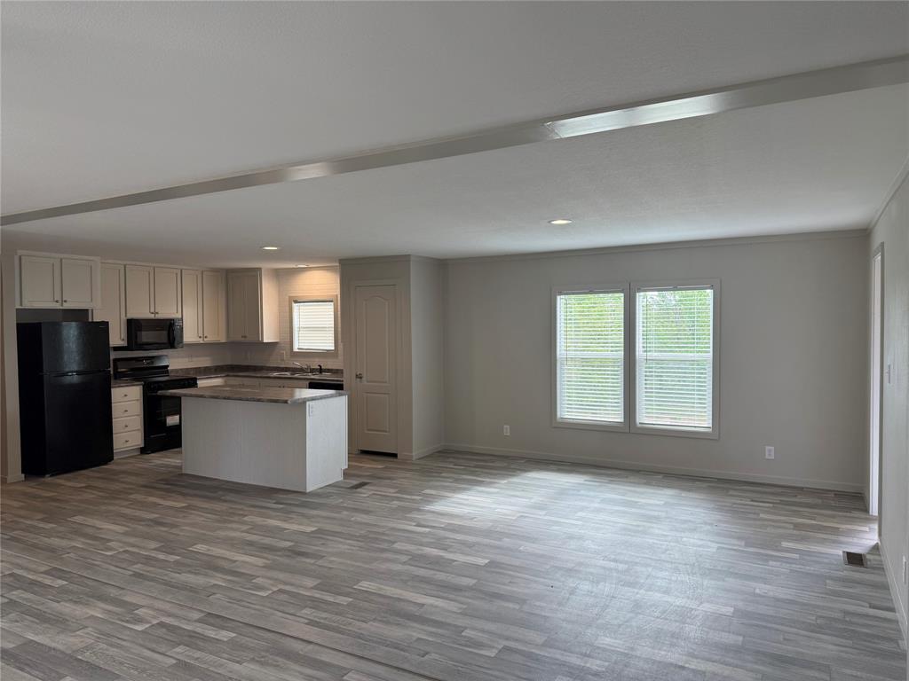 358 Reast Road Whitesboro, TX 76273 - Photo 4 of 21 a large kitchen with stainless steel appliances granite countertop a large counter top and a stove top oven