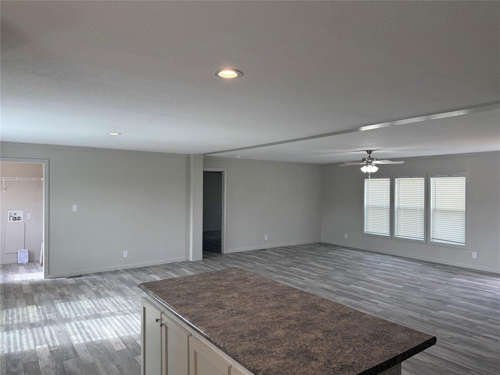 358 Reast Road Whitesboro, TX 76273 - Photo 5 of 21 an empty room with wooden floor and windows