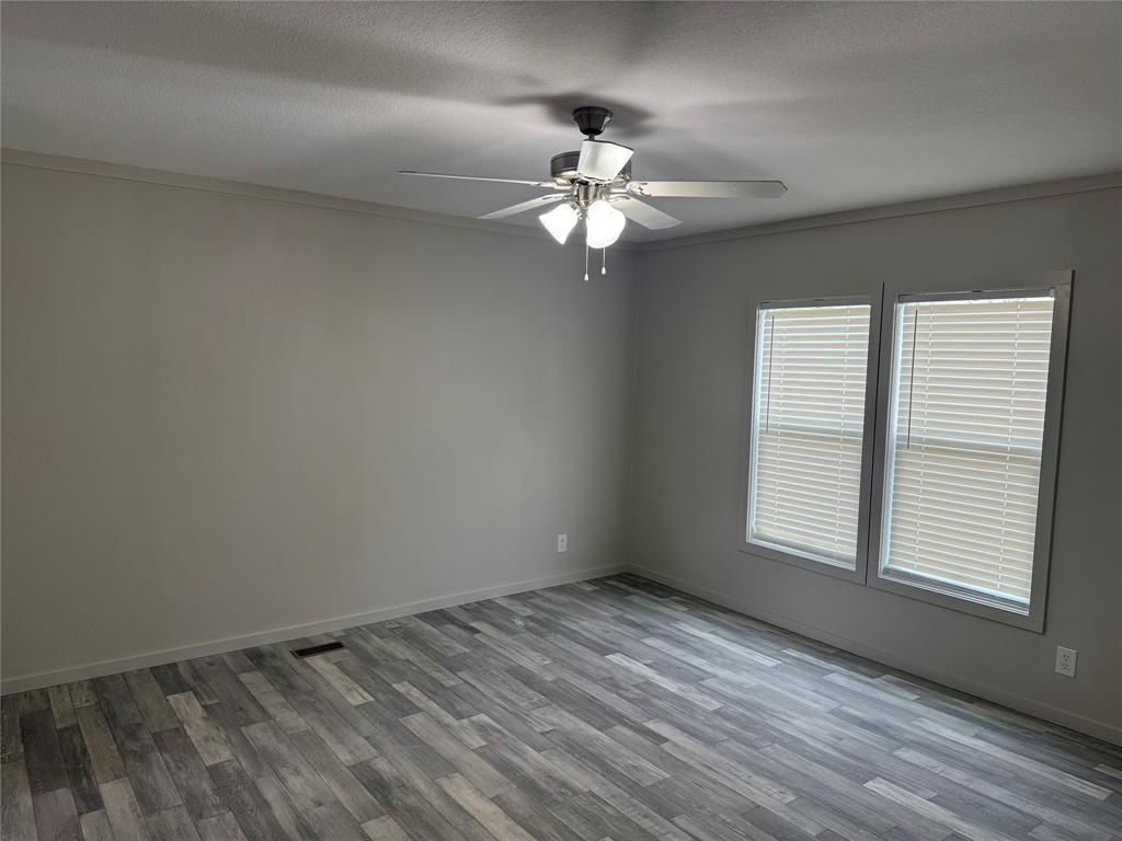 358 Reast Road Whitesboro, TX 76273 - Photo 7 of 21 an empty room with a window and a fan