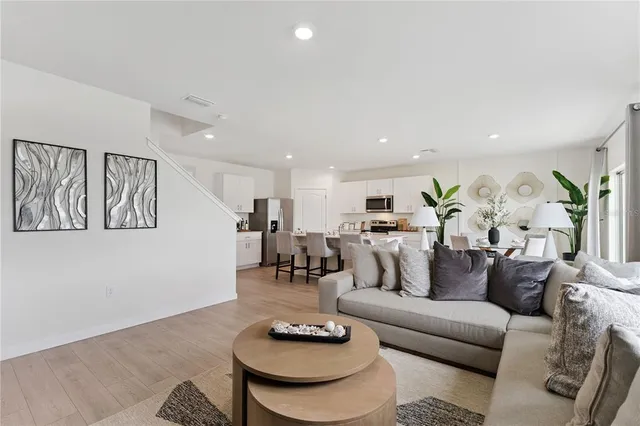 a living room with furniture and kitchen view