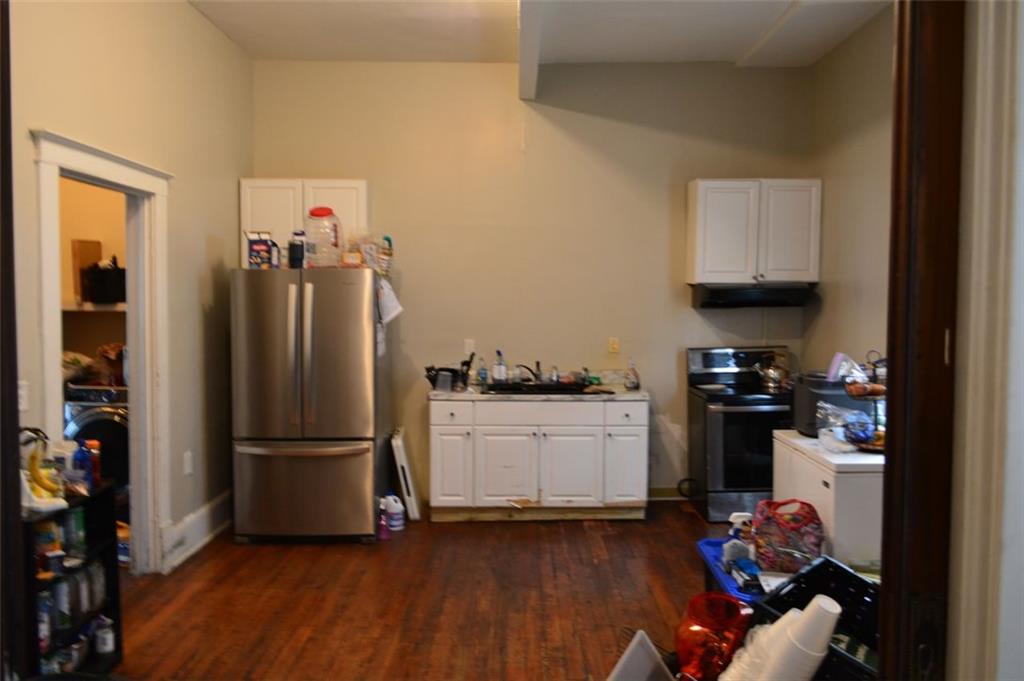 251 Ward Street Macon, GA 31201 - Photo 6 of 14 a kitchen with stainless steel appliances granite countertop a refrigerator stove and a sink