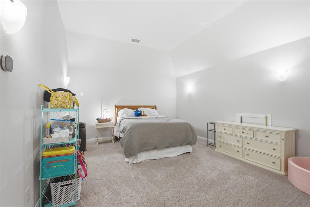 313 Tate Lane Anna, TX 75409 - Photo 25 of 30 Carpeted room with vaulted ceilings and neutral wall color