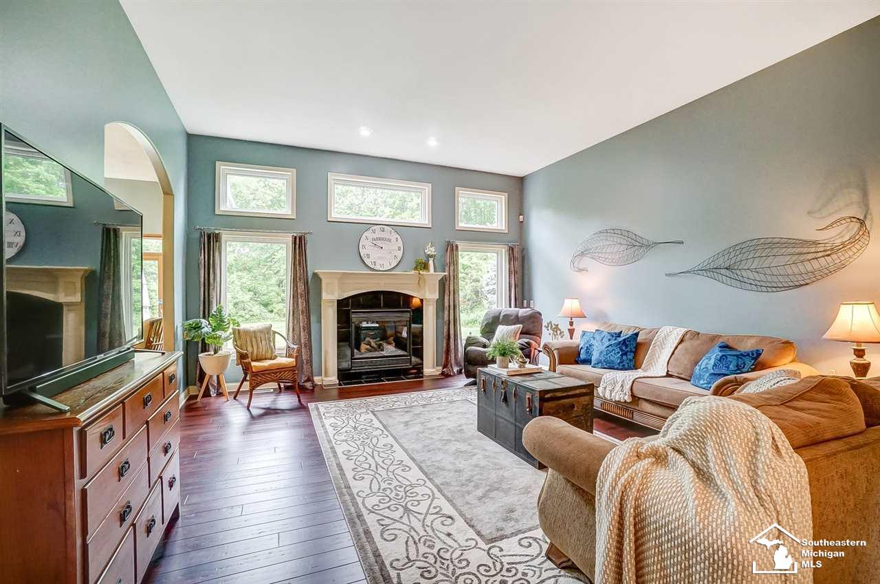 6475 Douglas Road Lambertville, MI 48144 - Photo 8 of 39 Entry opens right up to large great room that features a gas fireplace, bamboo flooring and a wall of windows.