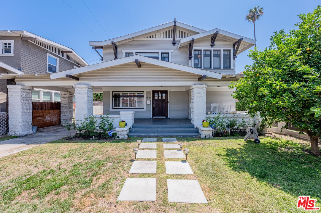 4530 West Washington Boulevard Los Angeles, CA 90016 - Photo 1 of 46 a front view of a house with yard and green space