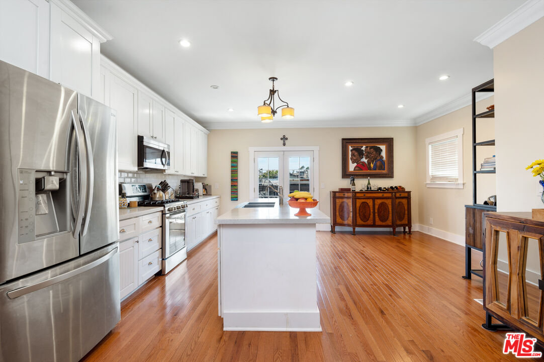 4530 West Washington Boulevard Los Angeles, CA 90016 - Photo 13 of 46 a kitchen with sink refrigerator and microwave
