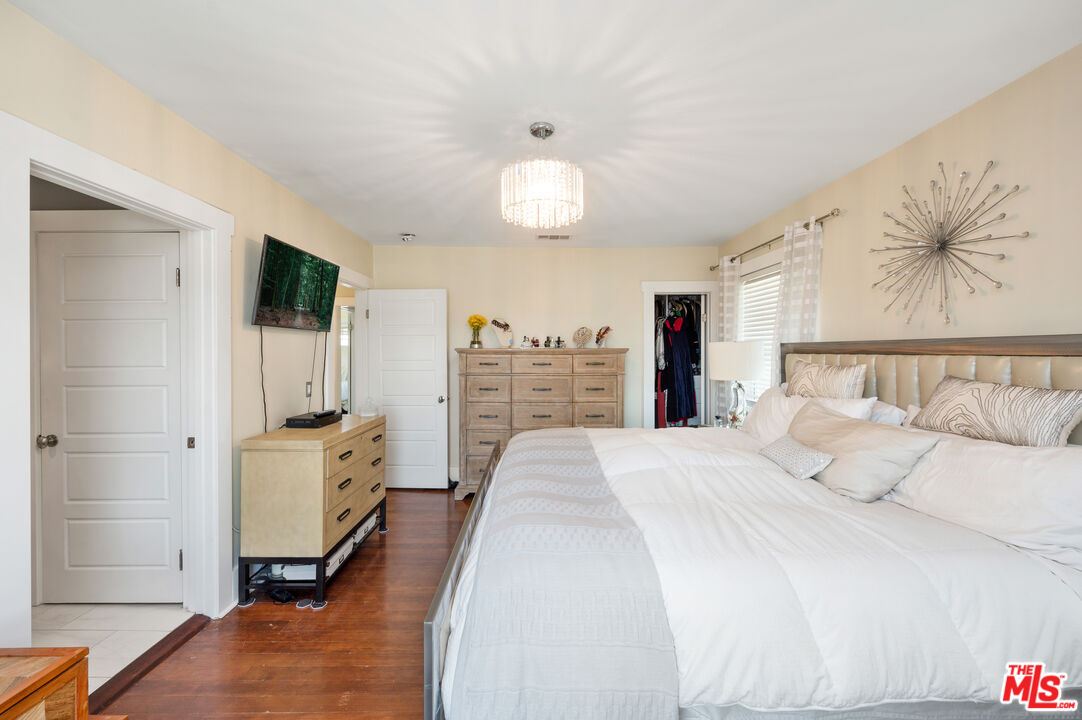4530 West Washington Boulevard Los Angeles, CA 90016 - Photo 27 of 46 a spacious bedroom with a bed and a walk in closet