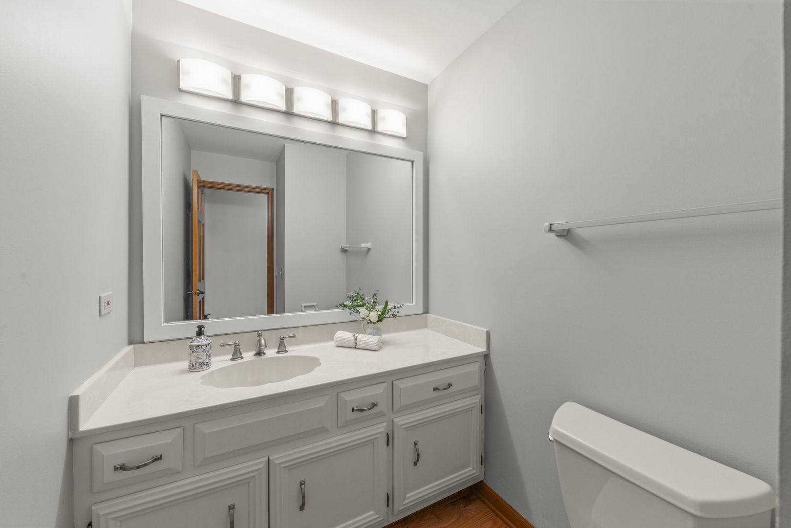 6621 Greene Road Woodridge, IL 60517 - Photo 18 of 42 a bathroom with a toilet a sink a vanity and mirror