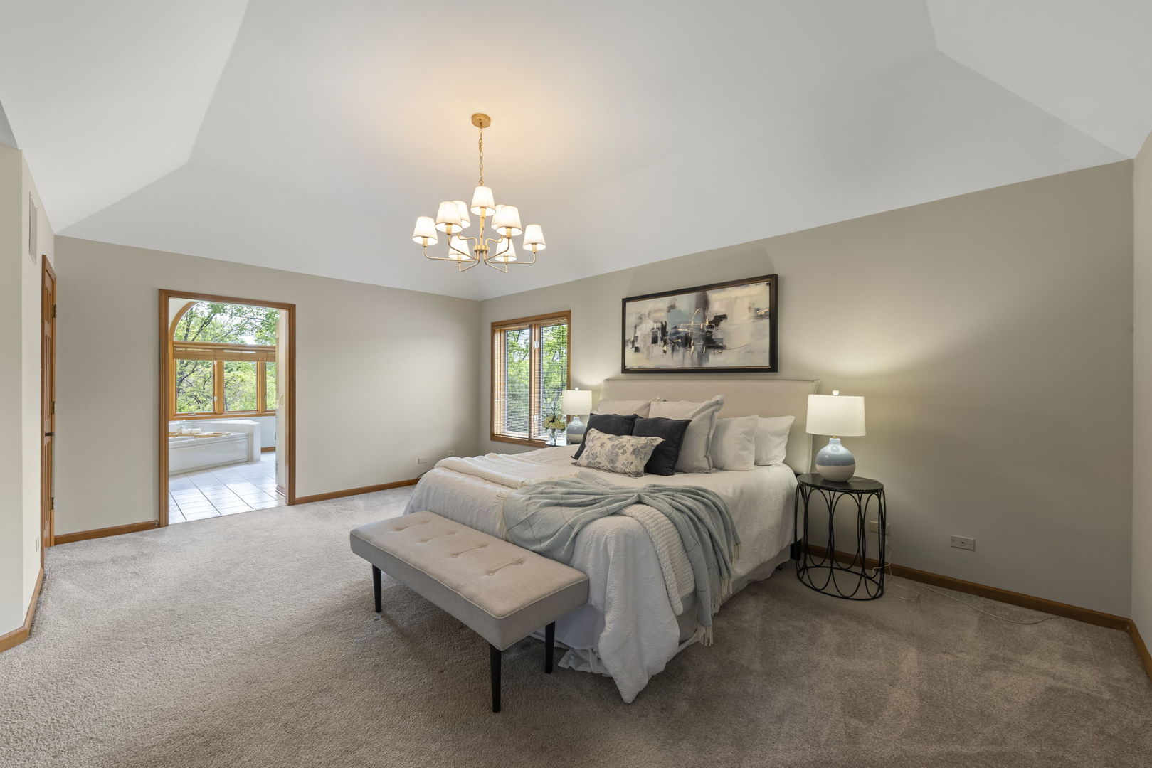 6621 Greene Road Woodridge, IL 60517 - Photo 19 of 42 a spacious bedroom with a bed and a chandelier