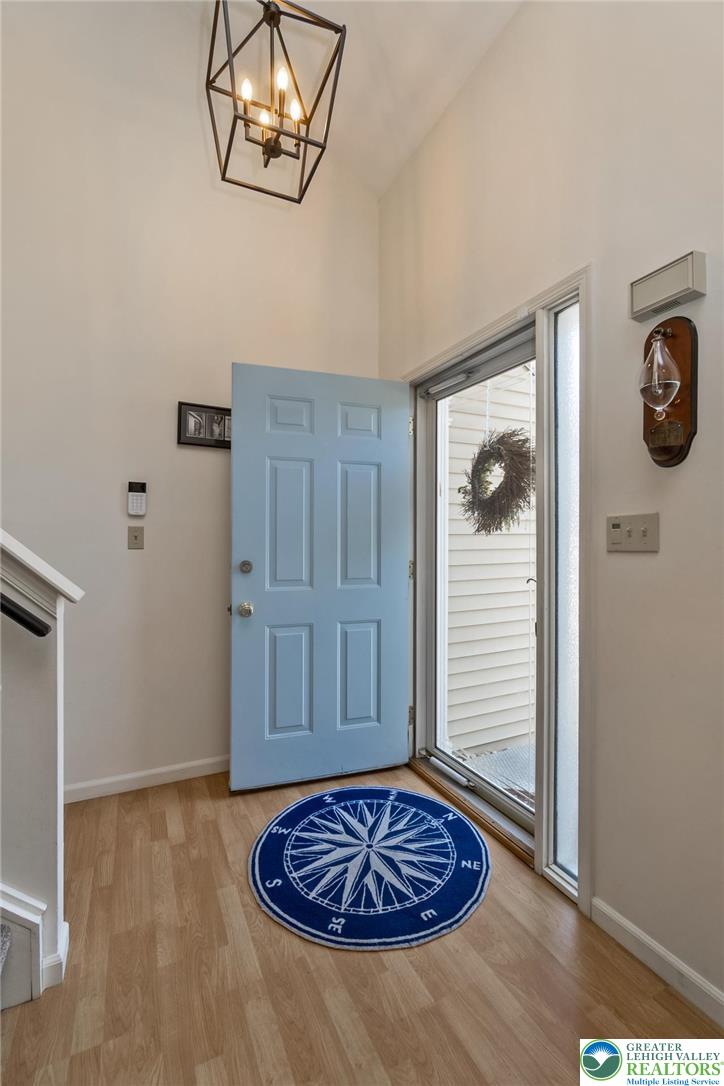 2314 Red Maple Drive Coplay, PA 18037 - Photo 7 of 73 Enter into a bright entryway featuring durable laminate flooring and a striking geometric light fixture.