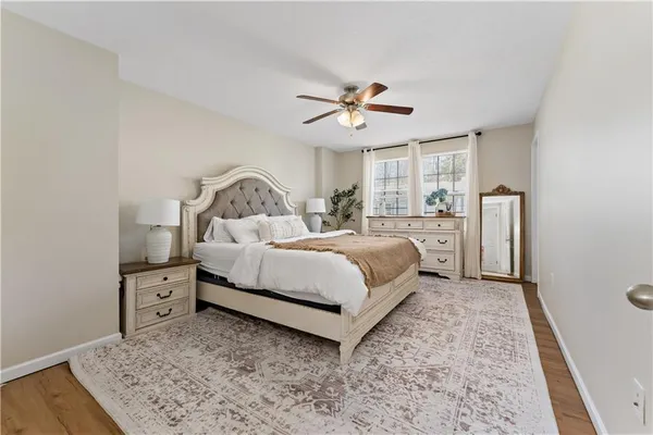 a bedroom with a large bed and a chandelier