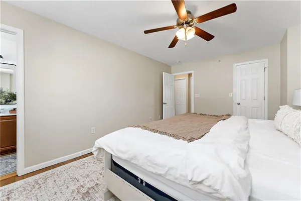 a bedroom with a bed and a ceiling fan
