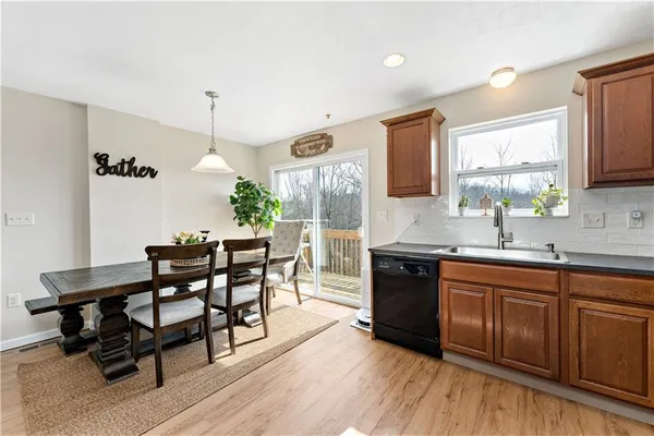 a kitchen with a table chairs sink and cabinets