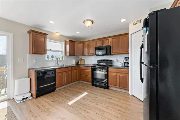 a kitchen with a refrigerator a stove top oven a sink and dishwasher