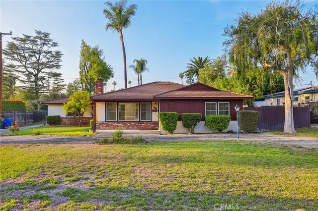 a front view of a house with swimming pool having outdoor seating