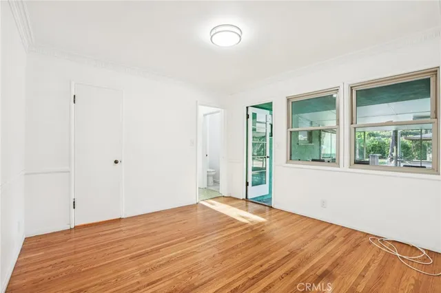 a kitchen with a table chairs refrigerator and cabinets