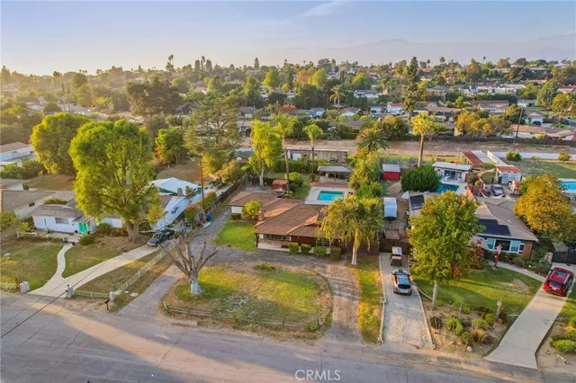 an aerial view of residential houses with outdoor space