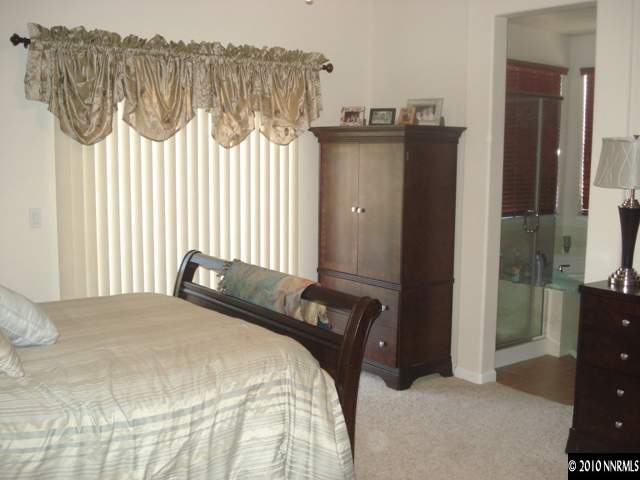 599 Needles Court Reno, NV 89521 - Photo 6 of 13 a bedroom with a bed and a dresser