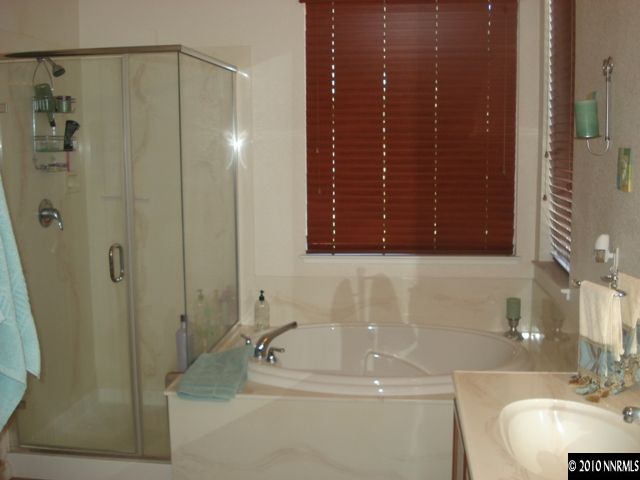 599 Needles Court Reno, NV 89521 - Photo 7 of 13 a bathroom with a sink and a mirror