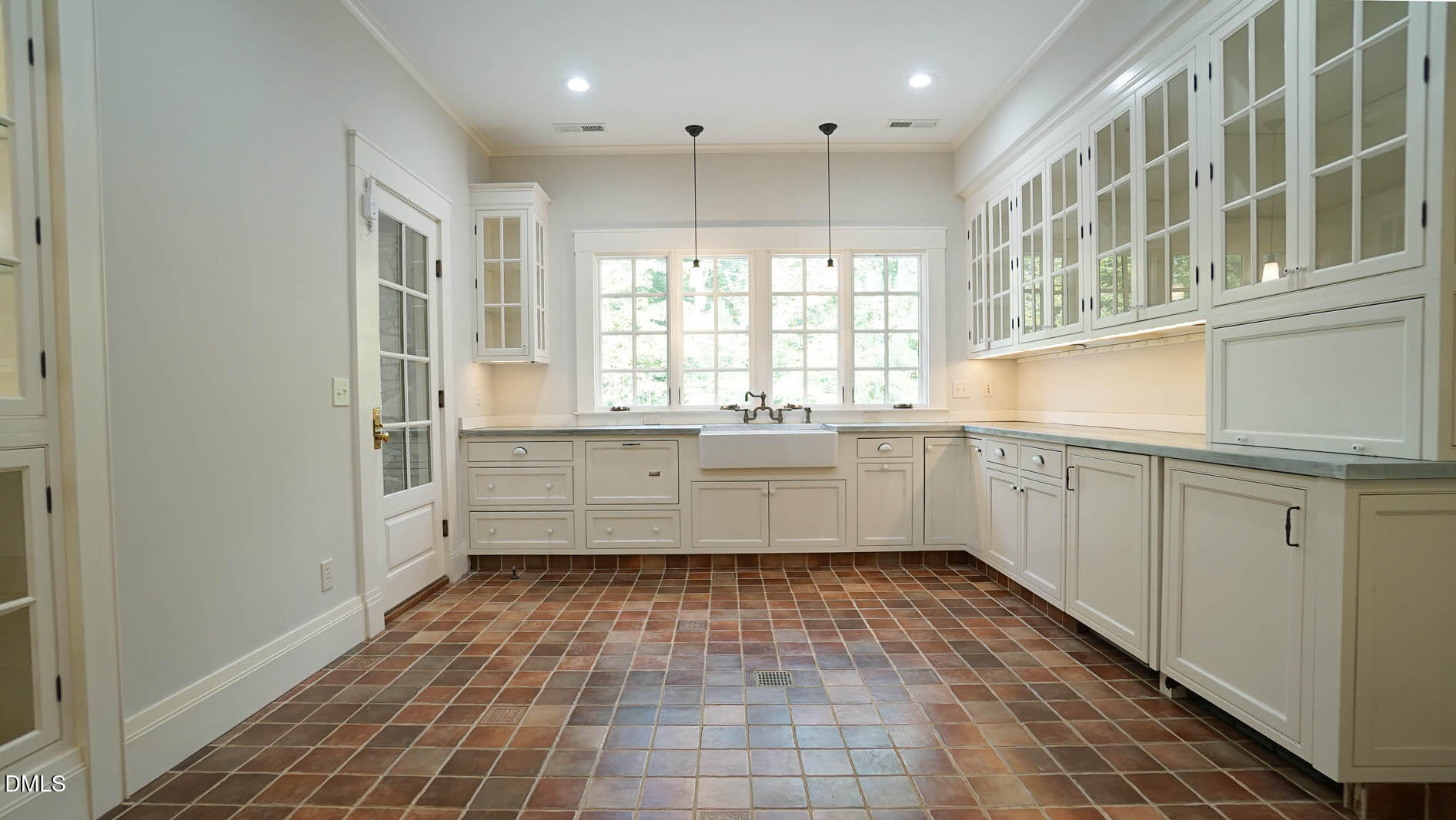 3105 Cone Manor Lane Raleigh, NC 27613 - Photo 89 of 101 a large white kitchen with a sink a window and stainless steel appliances