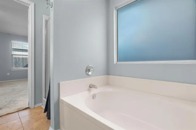 a white bath tub sitting next to a small sink