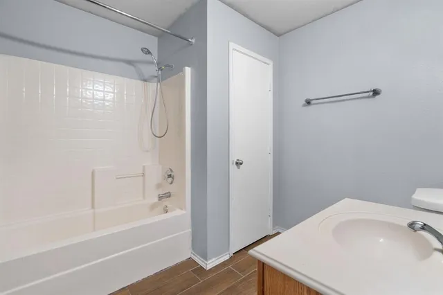 a bathroom with a shower and a sink