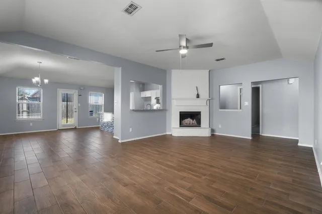 a view of kitchen with refrigerator cabinet and open cabinets