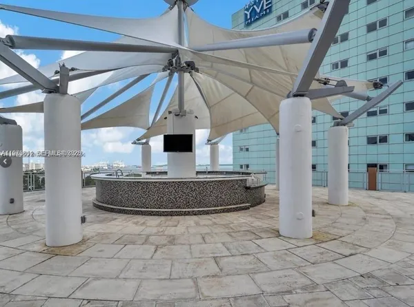 a room with lots of windows and a chandelier