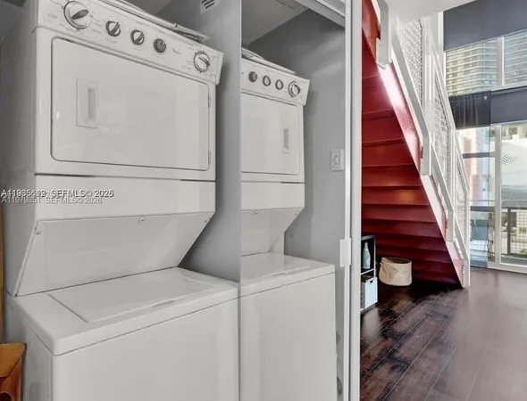 a view of washer and dryer with wooden floor