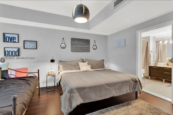a bedroom with a bed and dresser