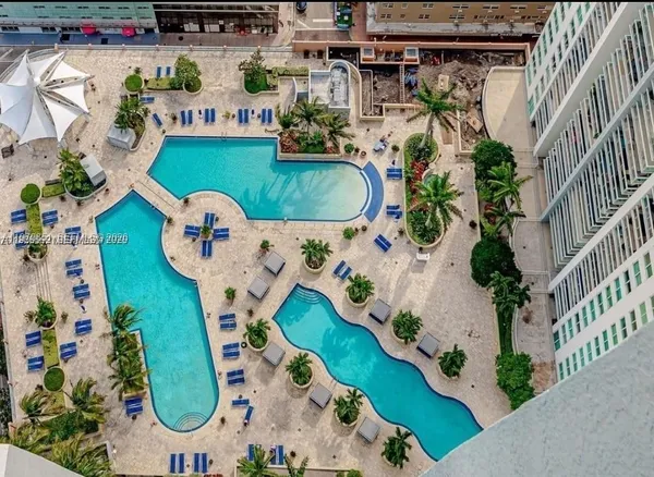 an aerial view of a swimming pool patio and outdoor seating