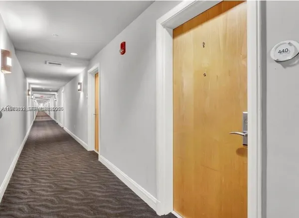 a view of hallway with wooden floor