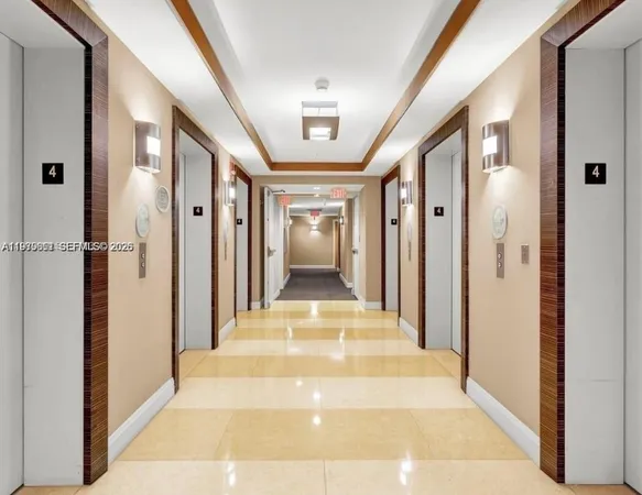 a view of a hallway with wooden floor and living room