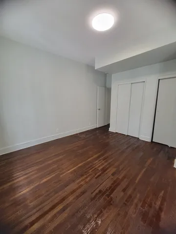 a view of room with wooden floor