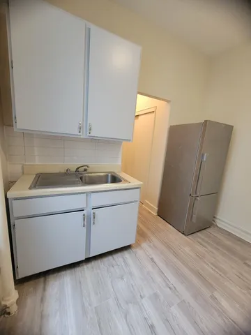 a room with cabinets and wooden floor