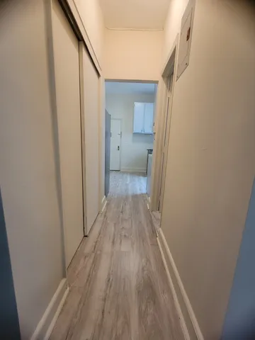 a view of a room with wooden floor and staircase