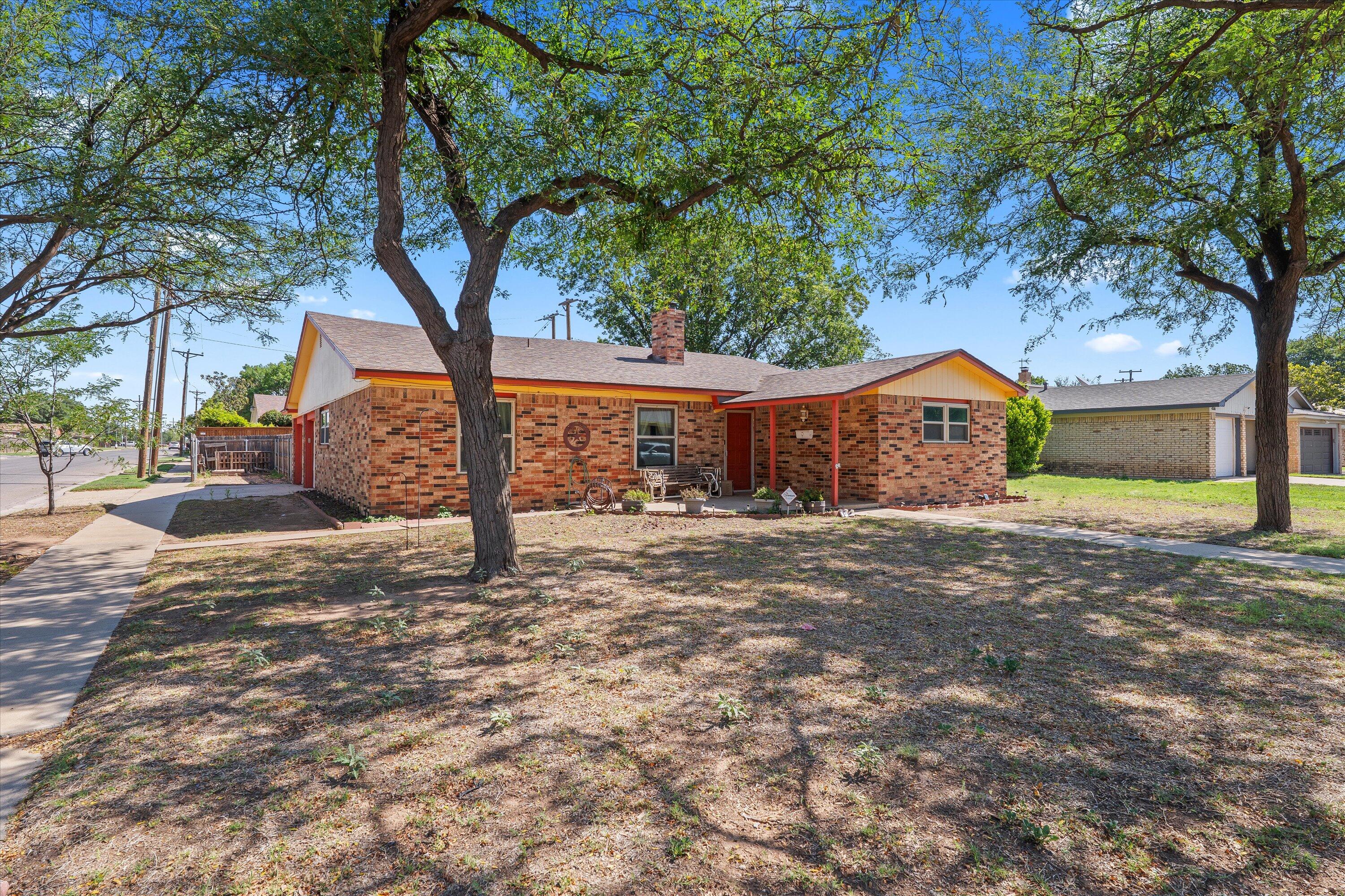 4520 54th Street Lubbock, TX 79414 - Photo 2 of 32 a front view of a house with street yard and tree s