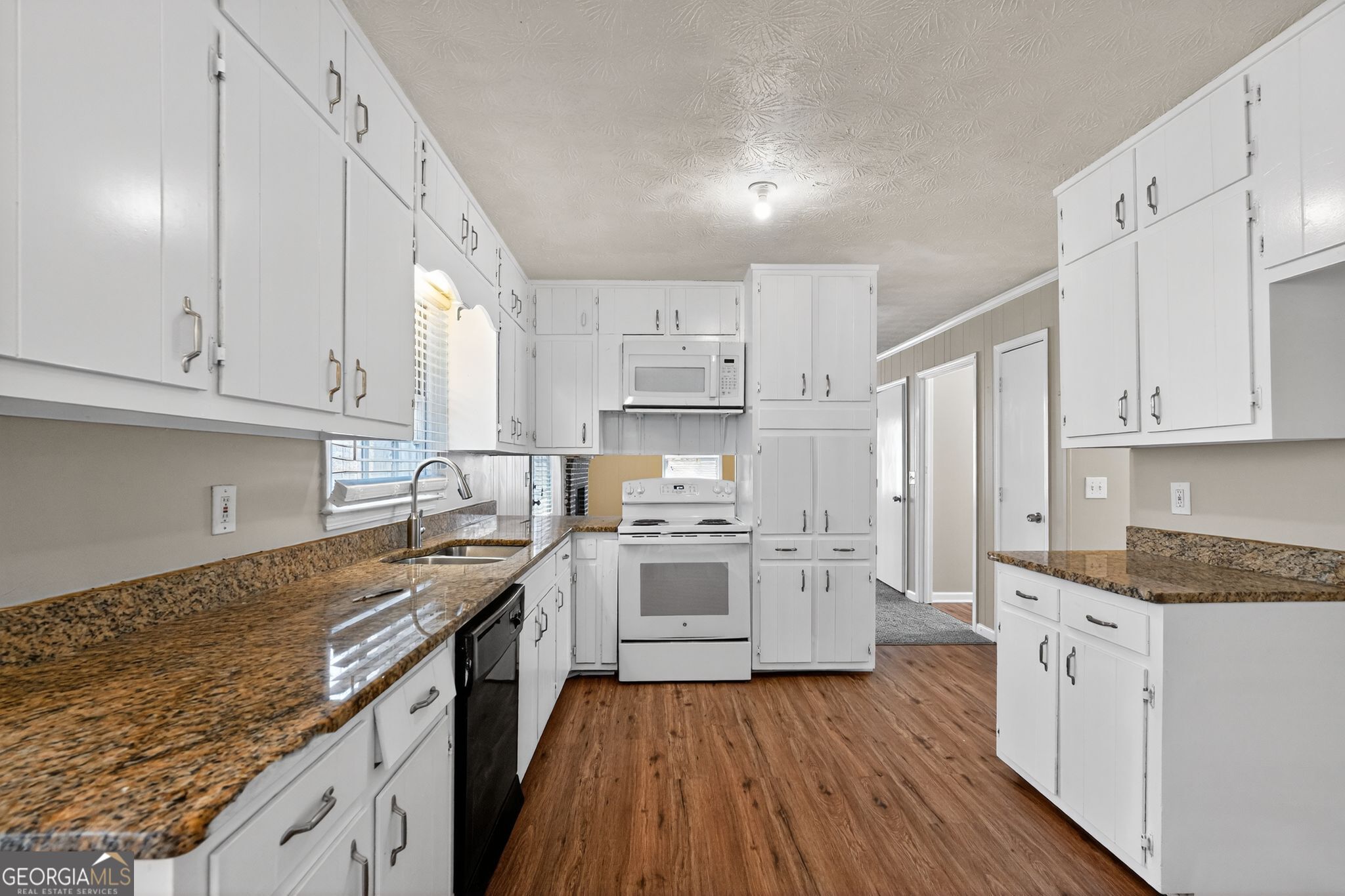4716 Jakes Trail Decatur, GA 30034 - Photo 11 of 34 a kitchen with granite countertop white cabinets and white appliances