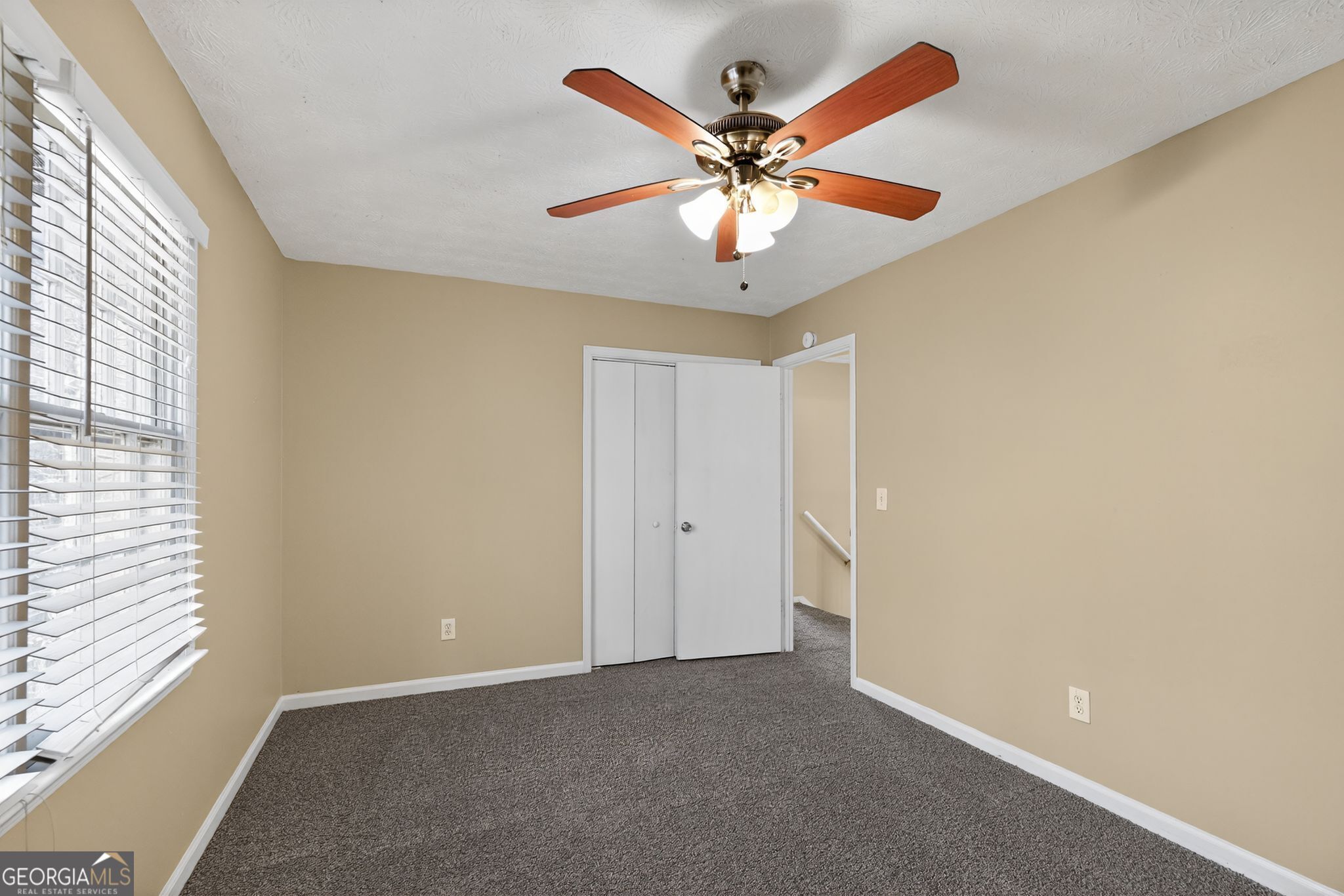 4716 Jakes Trail Decatur, GA 30034 - Photo 23 of 34 an empty room with a window and a fan