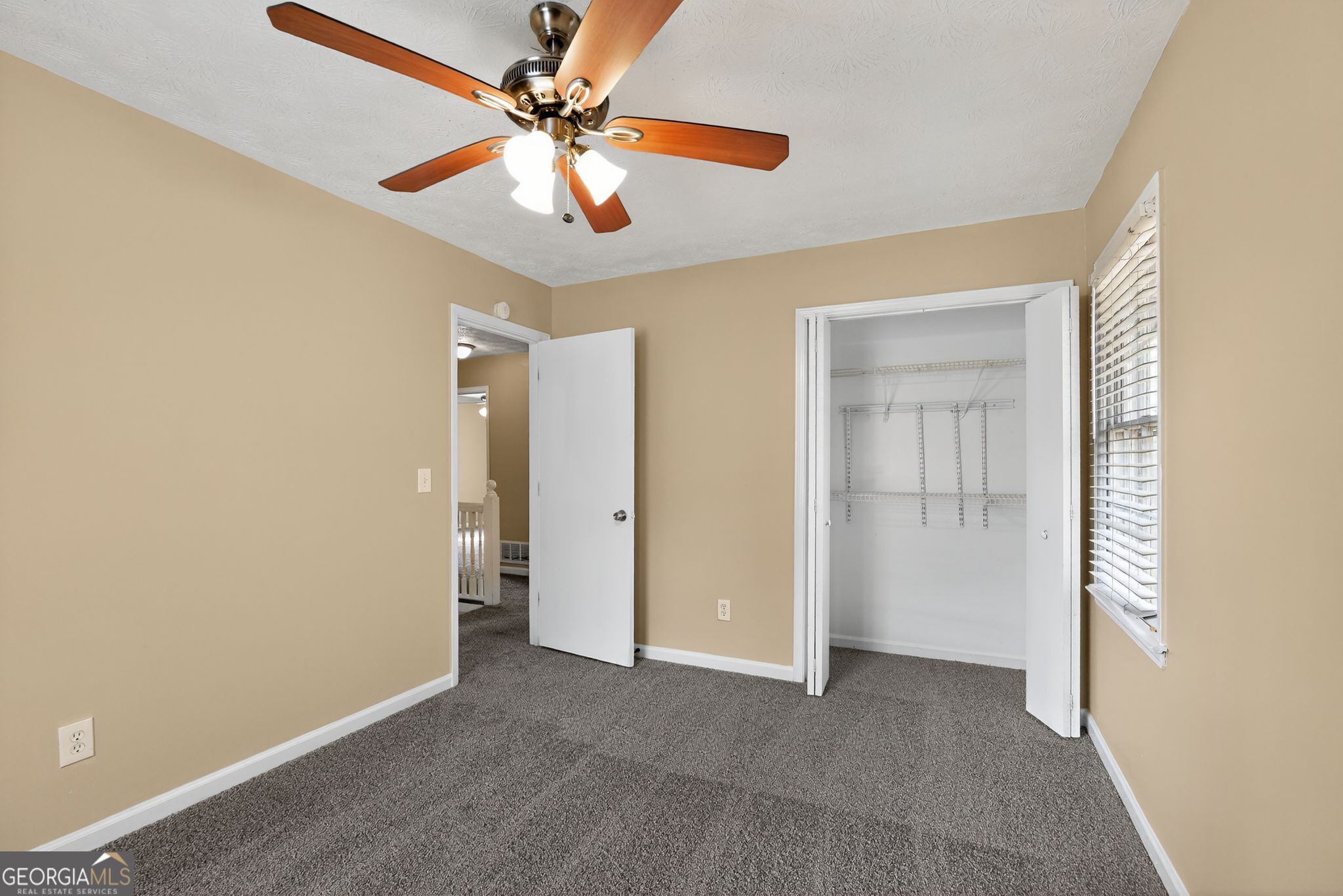 4716 Jakes Trail Decatur, GA 30034 - Photo 24 of 34 an empty room with closet and a ceiling fan