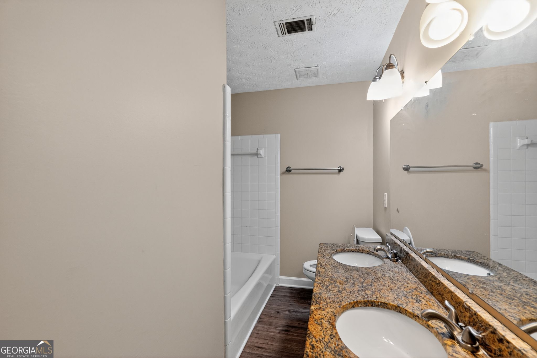 4716 Jakes Trail Decatur, GA 30034 - Photo 27 of 34 a bathroom with a granite countertop sink mirror vanity and toilet