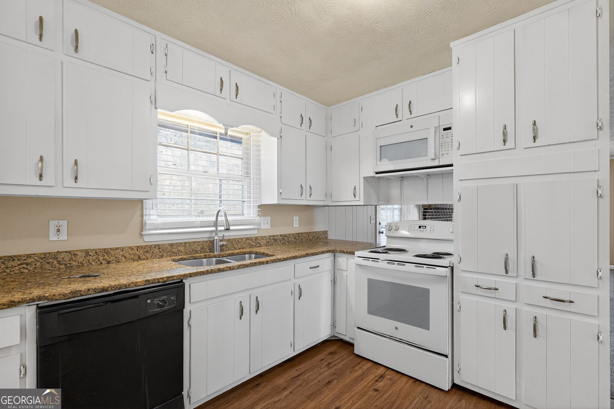 4716 Jakes Trail Decatur, GA 30034 - Photo 8 of 34 a kitchen with cabinets stainless steel appliances a sink and window
