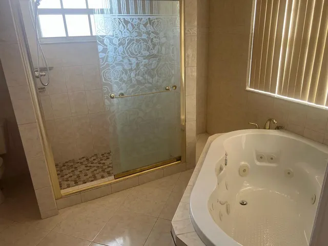 a bathroom with a tub and shower