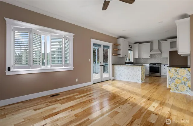 a view of empty room with fireplace and windows