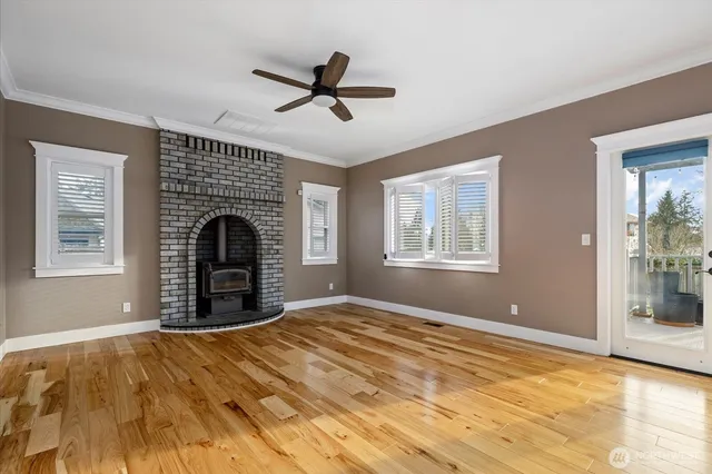 a view of empty room with fireplace and windows