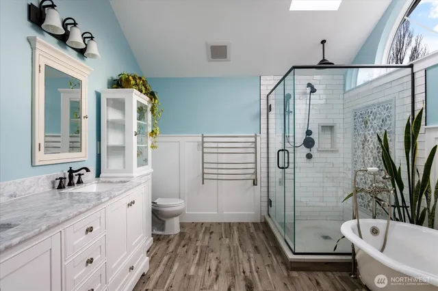 a bathroom with double vanity sink two mirror and window