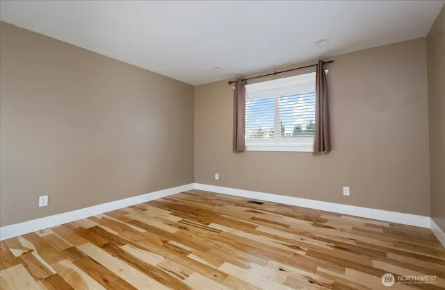a view of a room with wooden floor and cabinet